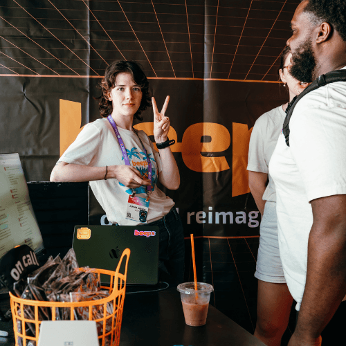 A woman giving a peace sign while standing next to a man