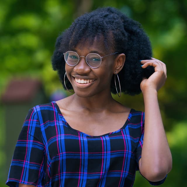 A woman wearing glasses and a plaid shirt