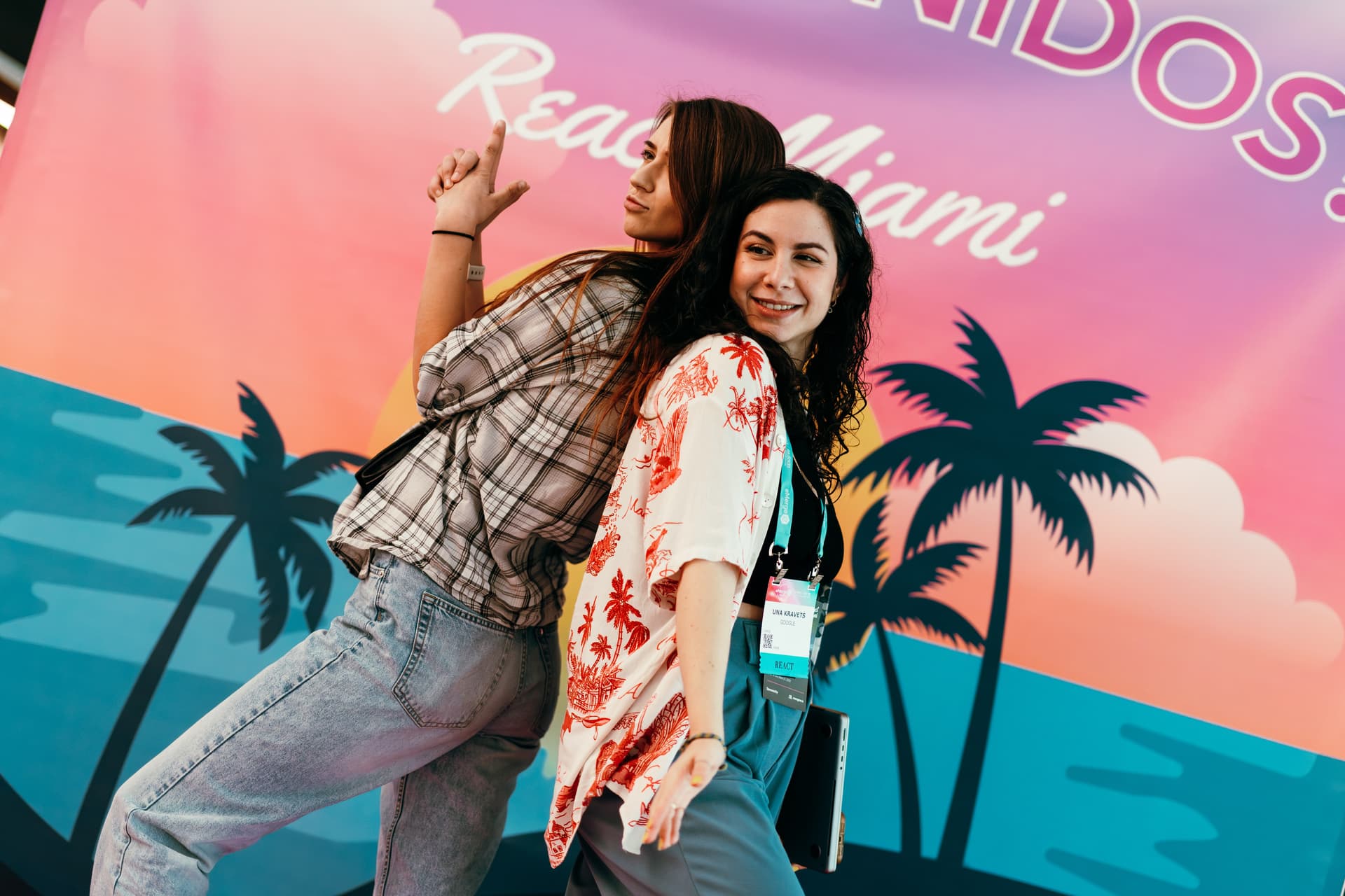 A couple of people that are standing in front of a sign