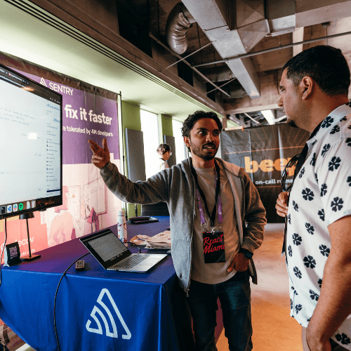 Two men standing in front of a screen