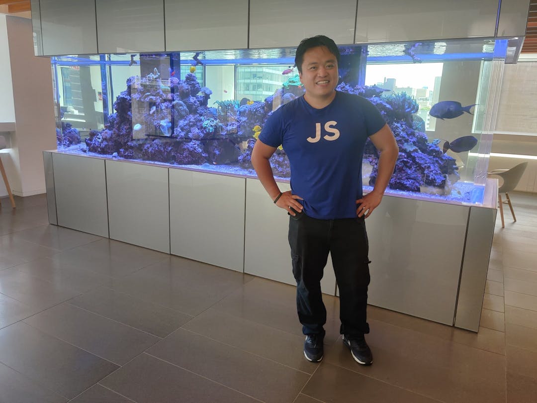 A man standing in front of a fish tank