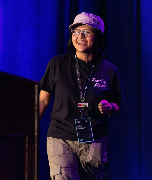 A woman speaking on stage.